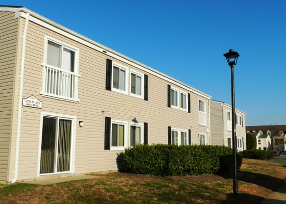 Village Green apartment buildings at dusk, with a lamp post lighting the walkway
