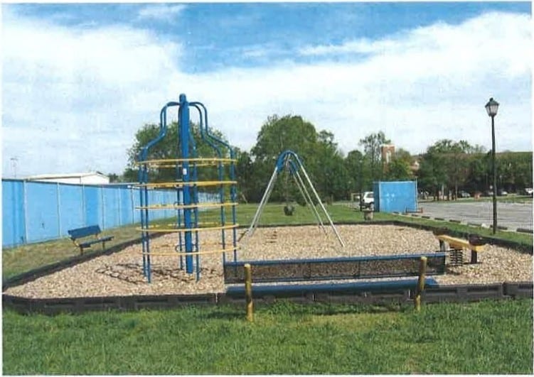 The community playground at Village Green with climbing equipment and swings