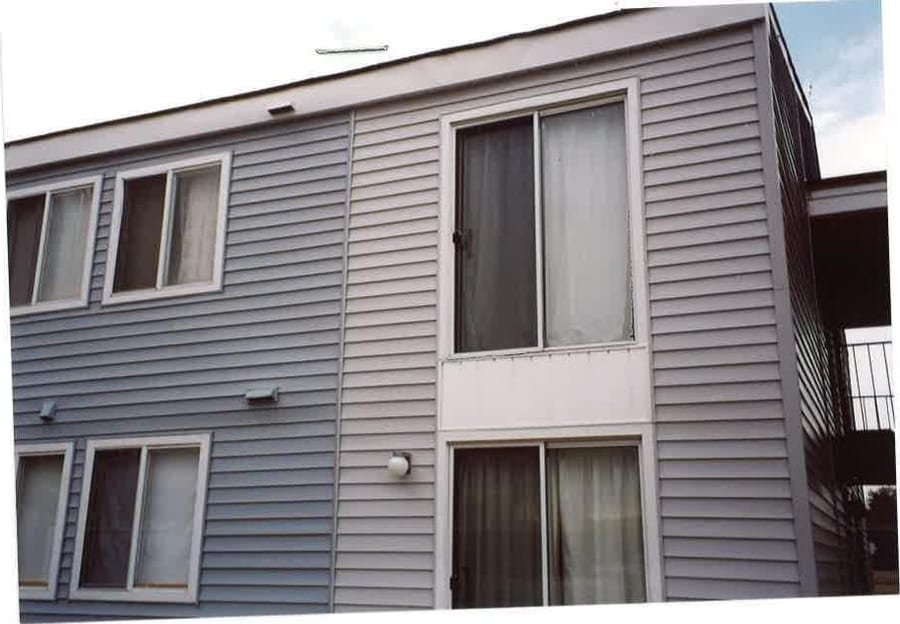 Two-story Village Green apartment homes with white trim